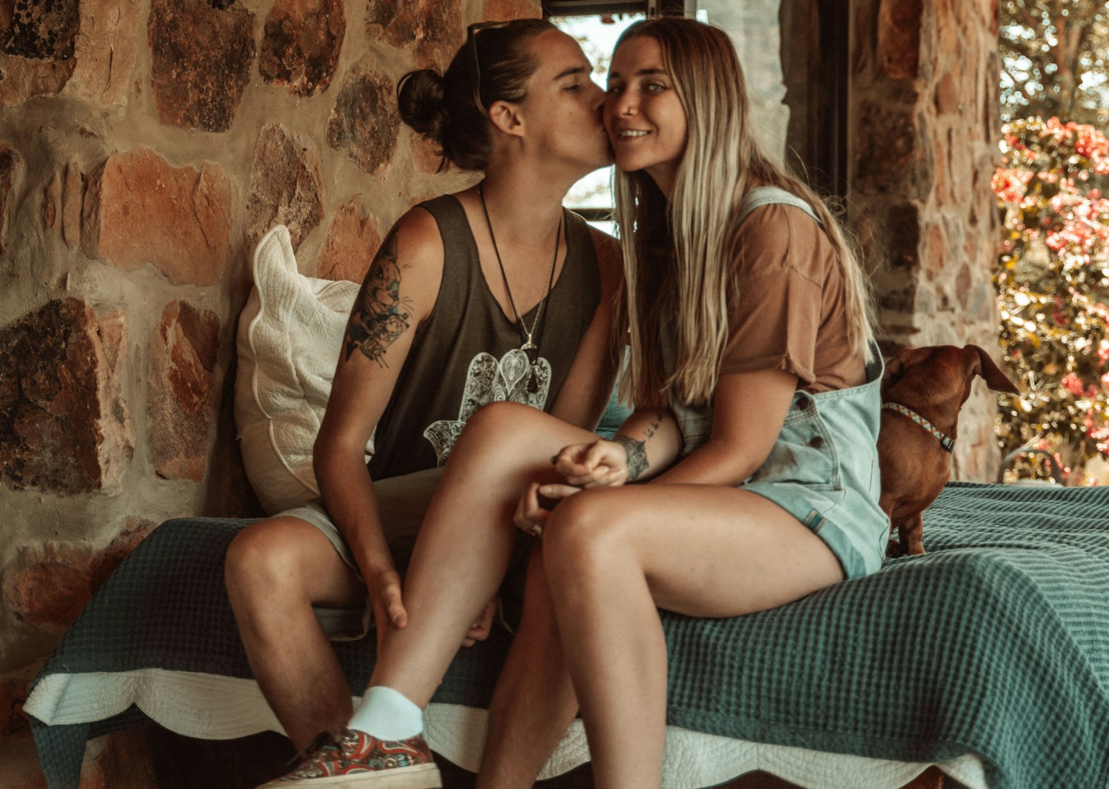 Lesbian couple sharing a kiss outdoors